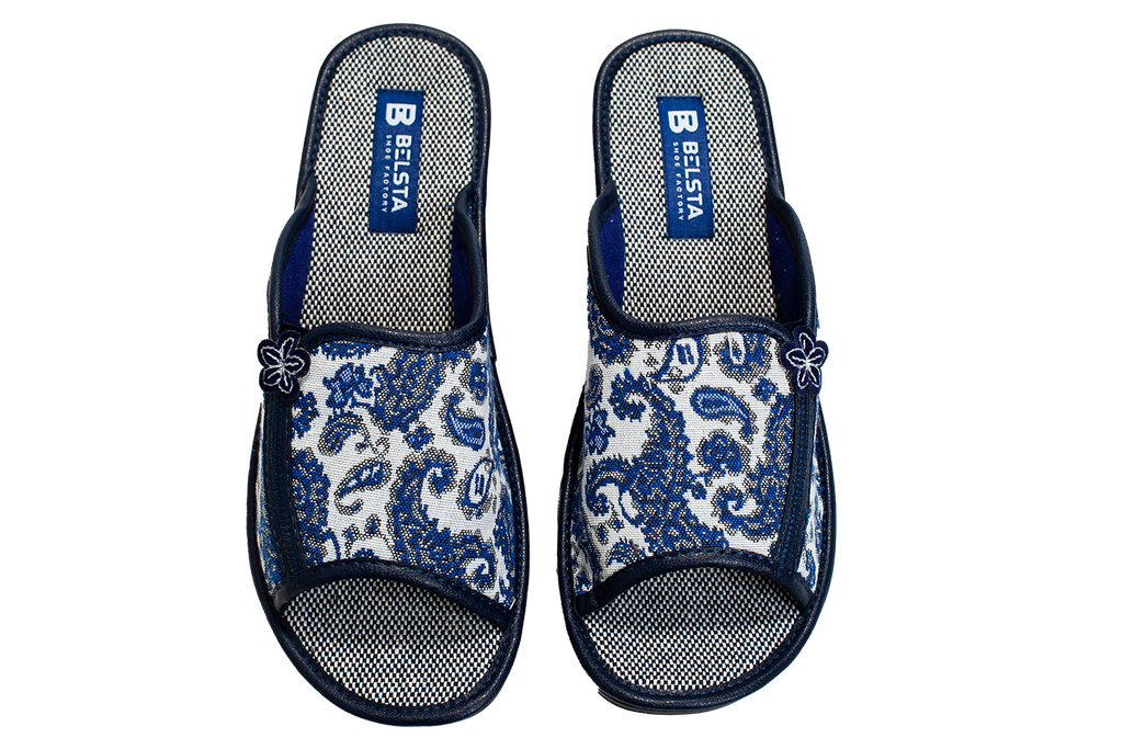 Women's open home slippers made of white textile with a patterned print, decorated with a flower