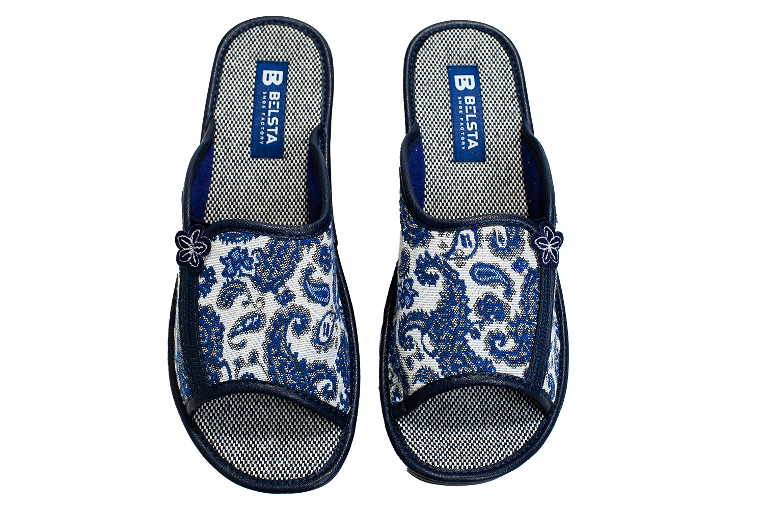 Women's open home slippers made of white textile with a patterned print, decorated with a flower