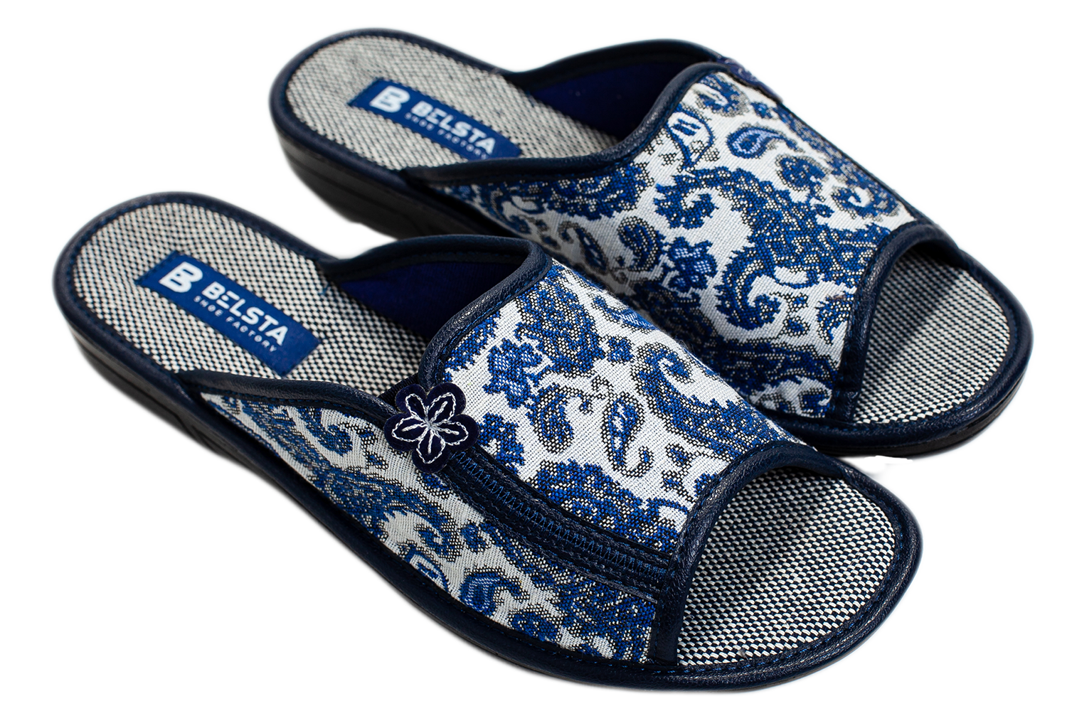 Women's open home slippers made of white textile with a patterned print, decorated with a flower